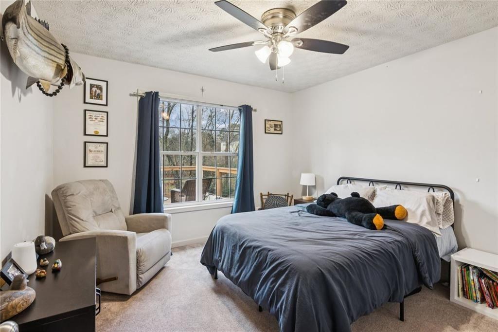 5595 Vaughn Road Woodstock, GA 30188 - Photo 23 of 42 a bedroom with a bed couch and window