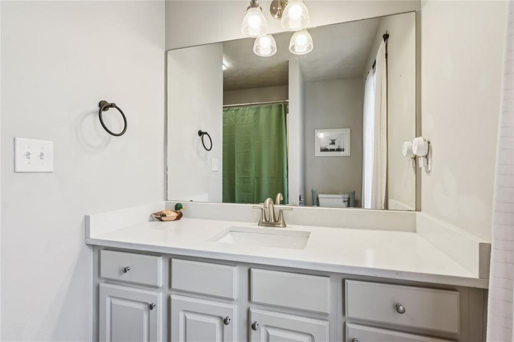 5595 Vaughn Road Woodstock, GA 30188 - Photo 25 of 42 a bathroom with a sink and a mirror