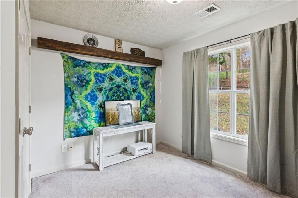 5595 Vaughn Road Woodstock, GA 30188 - Photo 26 of 42 a living room with furniture and a window