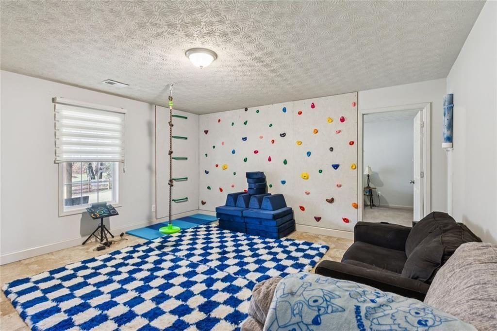 5595 Vaughn Road Woodstock, GA 30188 - Photo 27 of 42 a bedroom with furniture and a window