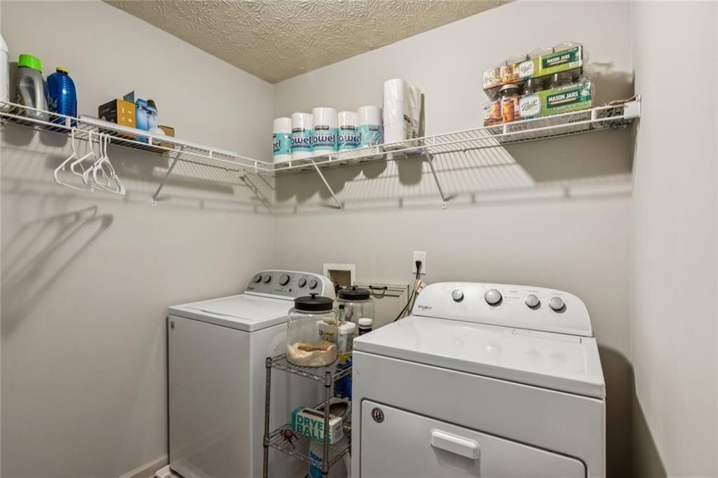 5595 Vaughn Road Woodstock, GA 30188 - Photo 31 of 42 a utility room with dryer washer and shoe rack