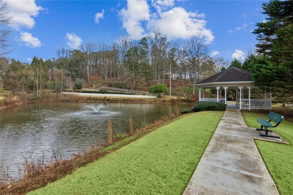 5595 Vaughn Road Woodstock, GA 30188 - Photo 41 of 42 a view of a lake with a yard