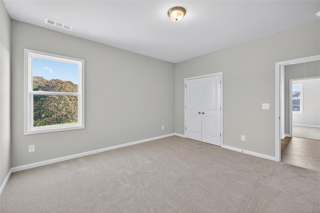 8845 Jot Em Down Road Gainesville, GA 30506 - Photo 40 of 87 an empty room with windows and closet