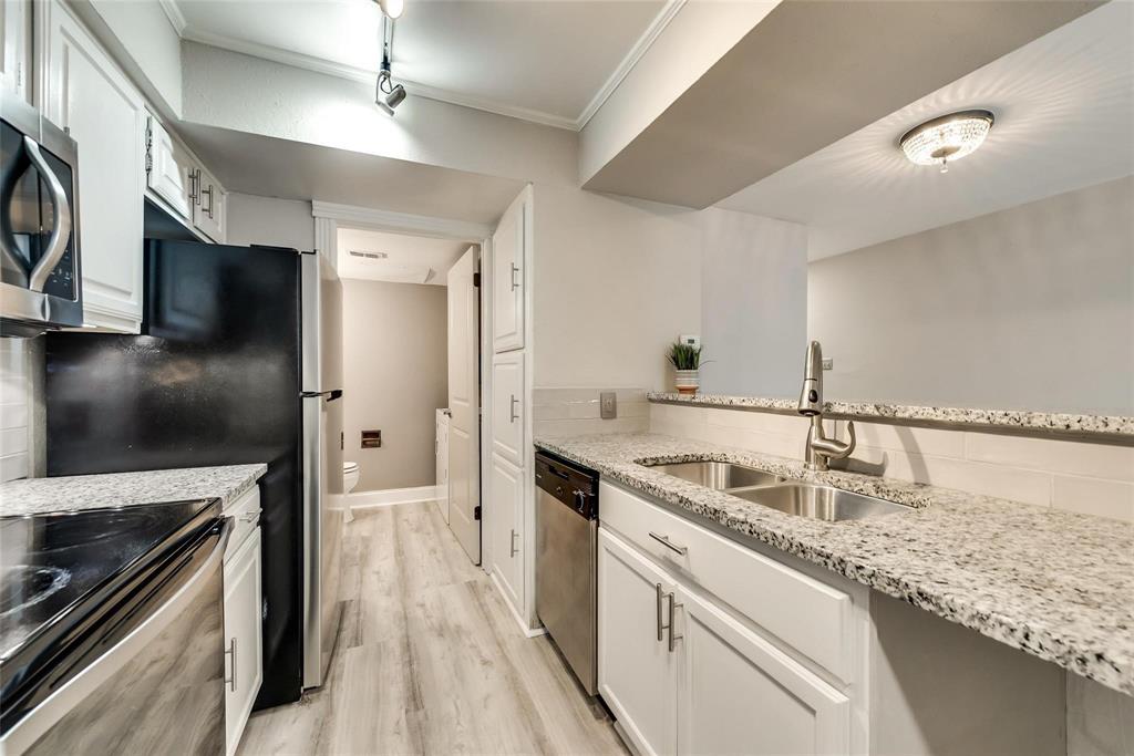 18240 Midway Road, Unit 302 Dallas, TX 75287 - Photo 9 of 33 a kitchen with stainless steel appliances granite countertop a sink and a stove