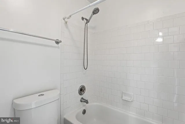 a bathroom with a bathtub and a toilet
