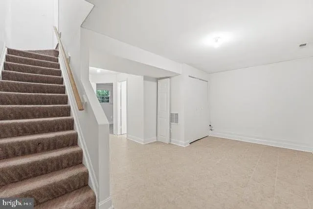 a view of an empty room with stairs