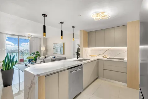 a kitchen with sink attached with living room