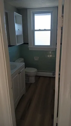 a bathroom with a toilet sink and mirror