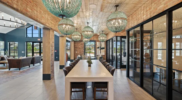 a living room with furniture a large window and a chandelier