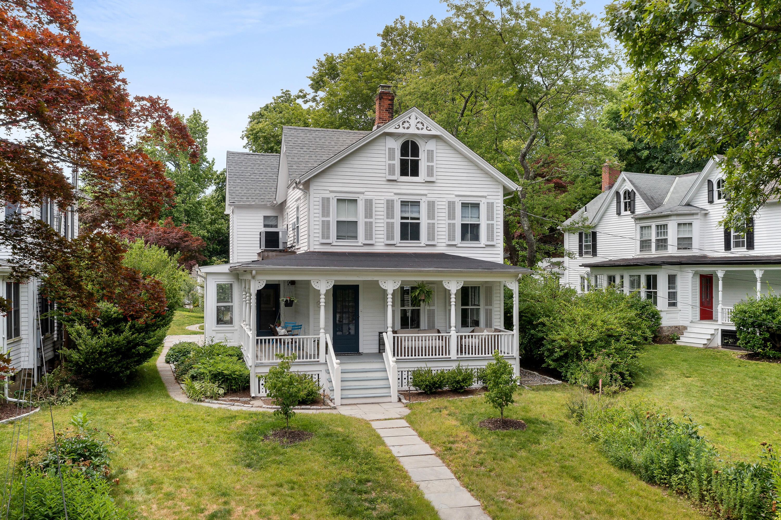 a front view of a house with yard and green space
