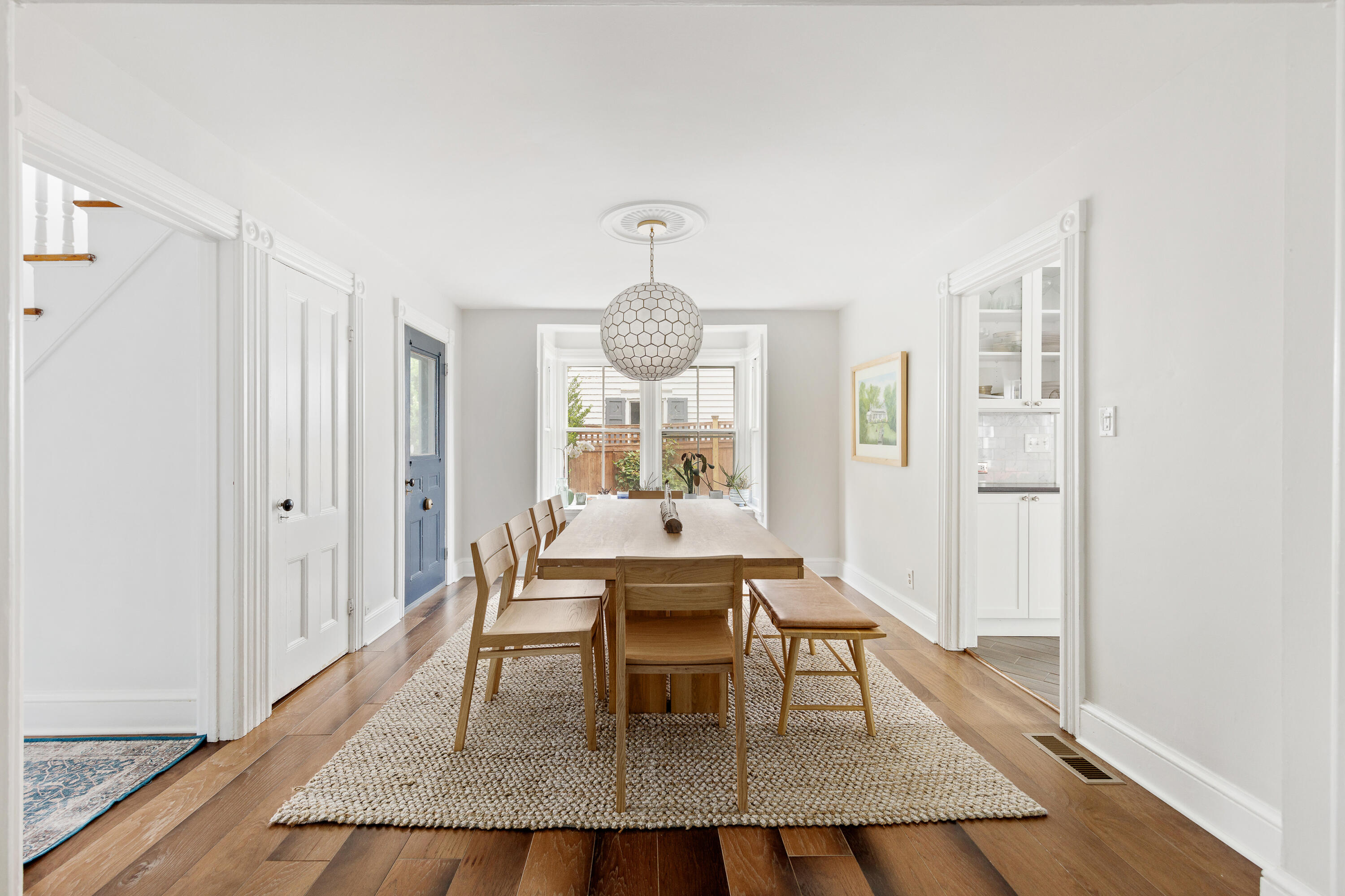 25 Raymond Street Darien, CT 06820 - Photo 6 of 28 a dining room with wooden floor a glass table and chairs