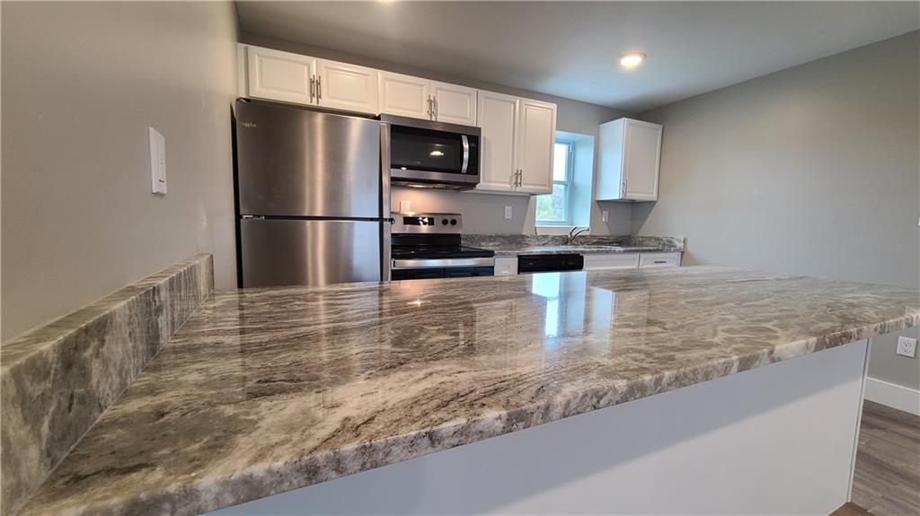 1331 Freeport Road Cheswick, PA 15024 - Photo 5 of 32 a kitchen with granite countertop a refrigerator a stove and a sink