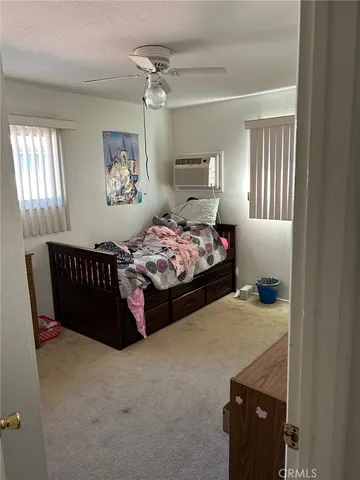 a bedroom with bed and window