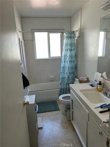 a bathroom with a sink a toilet and tub