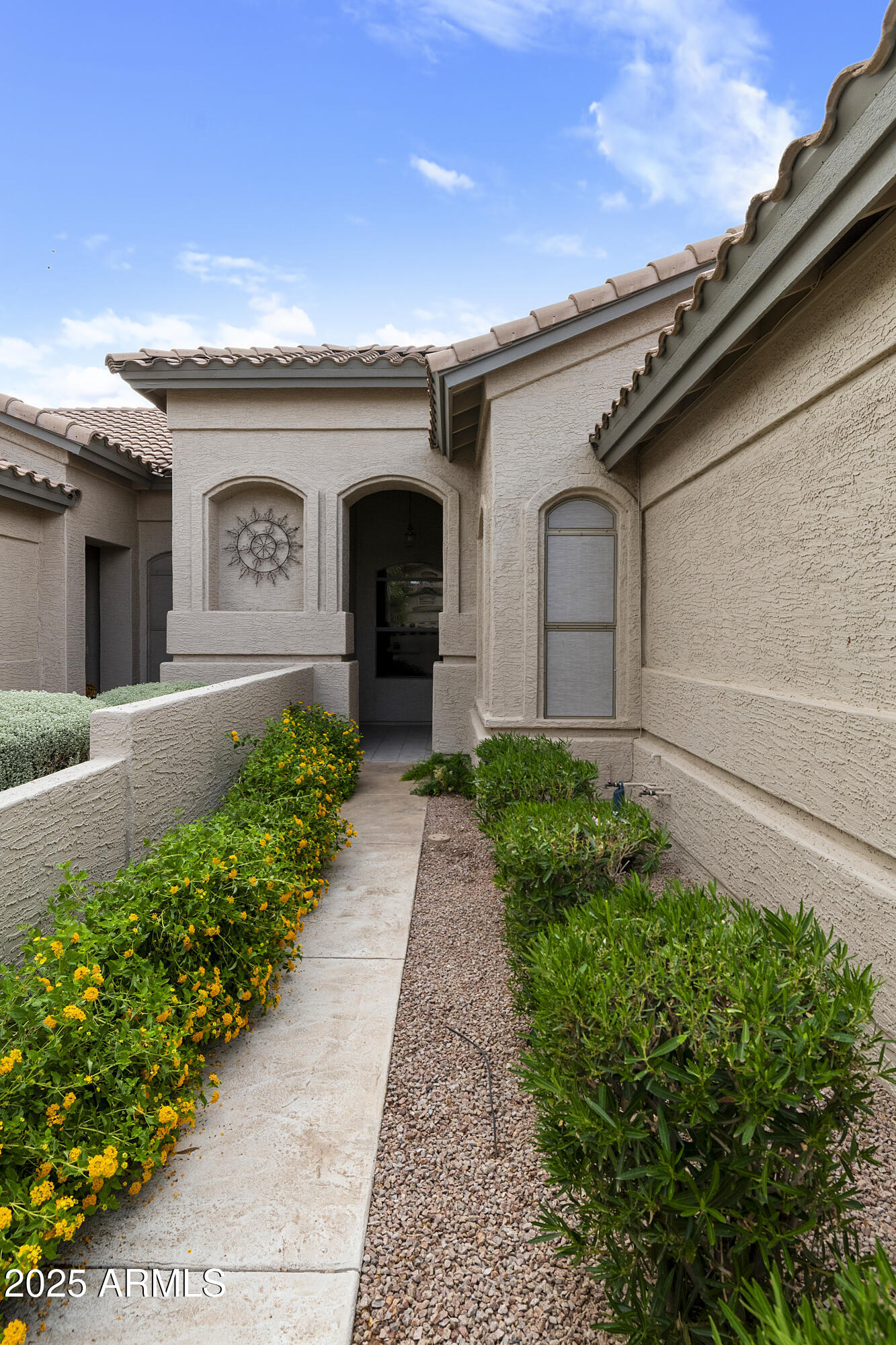 23745 South Vacation Way Sun Lakes, AZ 85248 - Photo 2 of 52 a front view of a house with garden