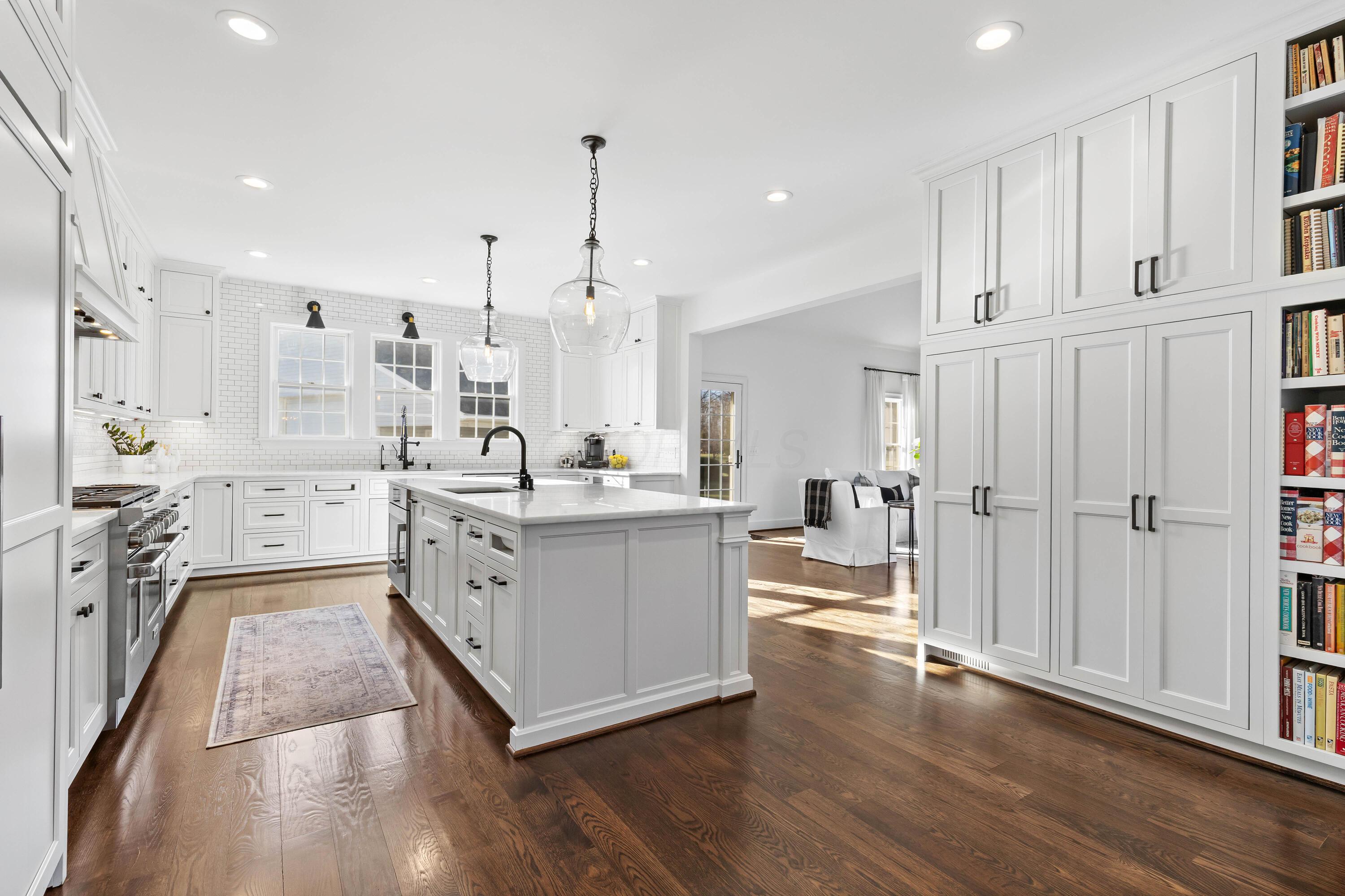 1364 Dale Ford Road Delaware, OH 43015 - Photo 28 of 112 • Hardwood flooring • White painted walls • Can lighting • Custom built white cabinets • Marble countertops • 10’ center island with pendant lighting & breakfast bar ledge • Wall pantry with pull-outs & book shelves • (2) big pendant lights • Wolf® drawer microwave • Bosch® dishwasher • (2) lazy susans • Single bowl, stainless steel sink with sprayer & reverse osmosis (negotiable) • Under cabinet lighting • Bosch® electric 36” oven with side swinging door • 48” Wolf® 8 burner gas stove with convection oven • Pot filler • Custom range hood (vents-out & return air) • 48” Sub-Zero® paneled refrigerator • Hidden outlets on island