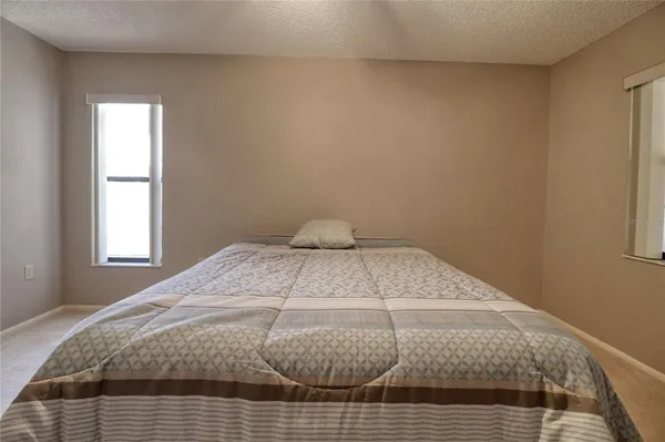 a bedroom with a bed and window