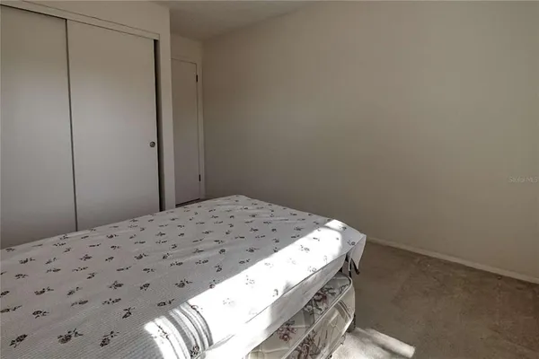 a bed sitting in a room next to a window