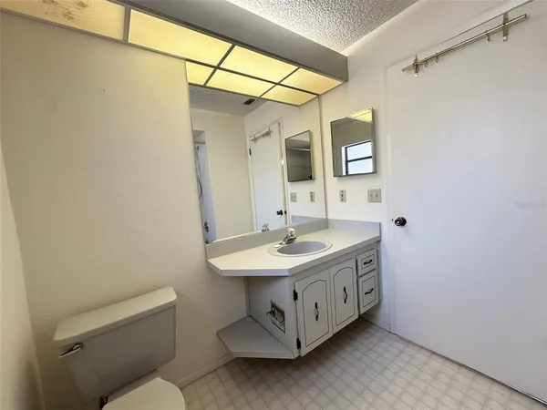 a bathroom with a sink a toilet and mirror
