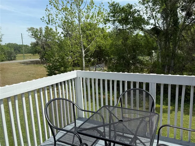 a view of balcony with wooden floor and outdoor seating