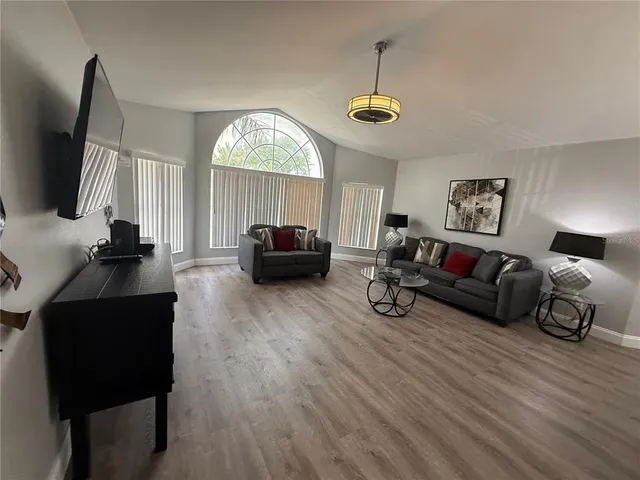 a living room with furniture and a flat screen tv