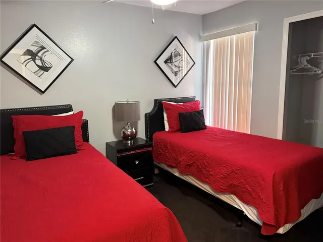 a bedroom with two beds and painting on the wall in it