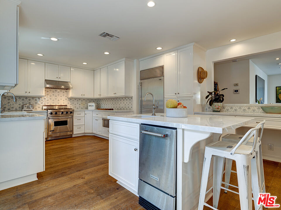 1314 Preston Way Venice, CA 90291 - Photo 12 of 30 a kitchen with a sink white cabinets and stainless steel appliances