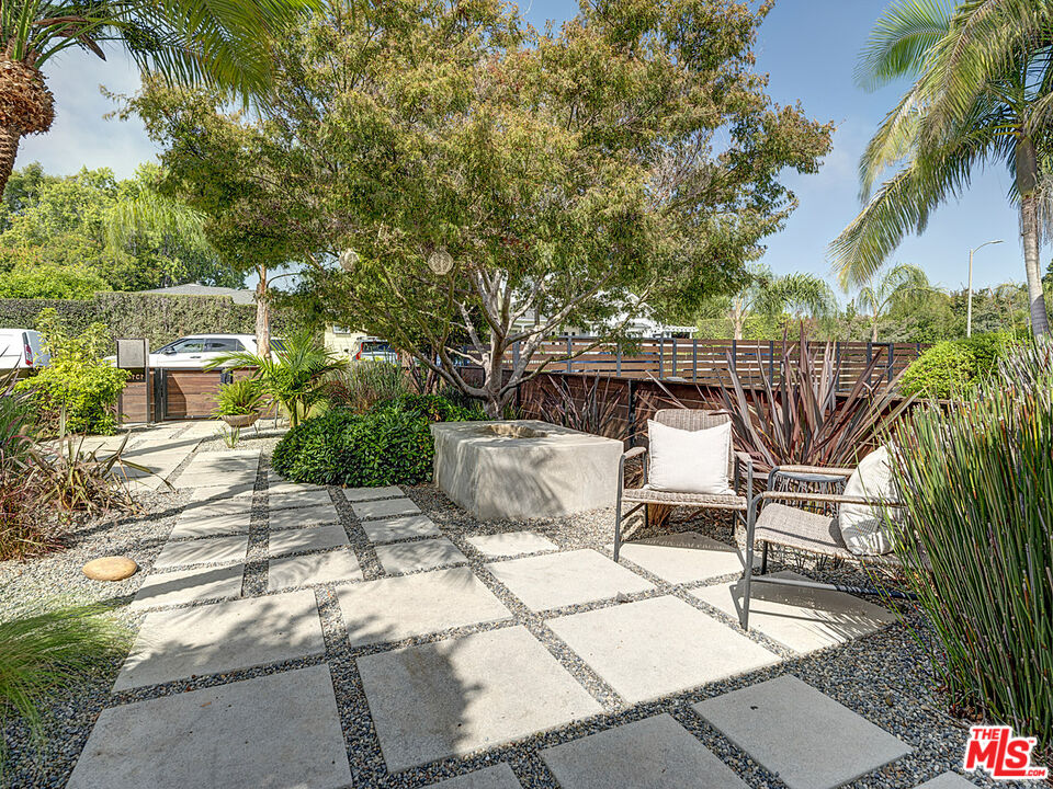 1314 Preston Way Venice, CA 90291 - Photo 5 of 30 a view of a patio with table and chairs potted plants and large tree