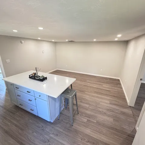 a kitchen with granite countertop a sink and a stove top oven