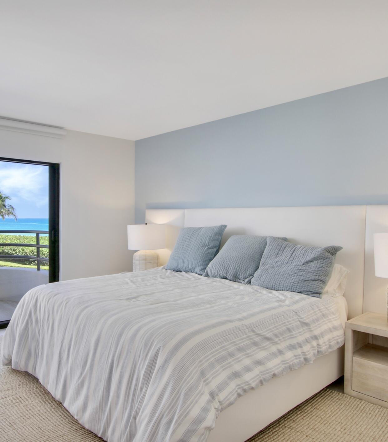 420 Celestial Way, Unit 303 Juno Beach, FL 33408 - Photo 24 of 39 a large bed sitting in a bedroom and a large window