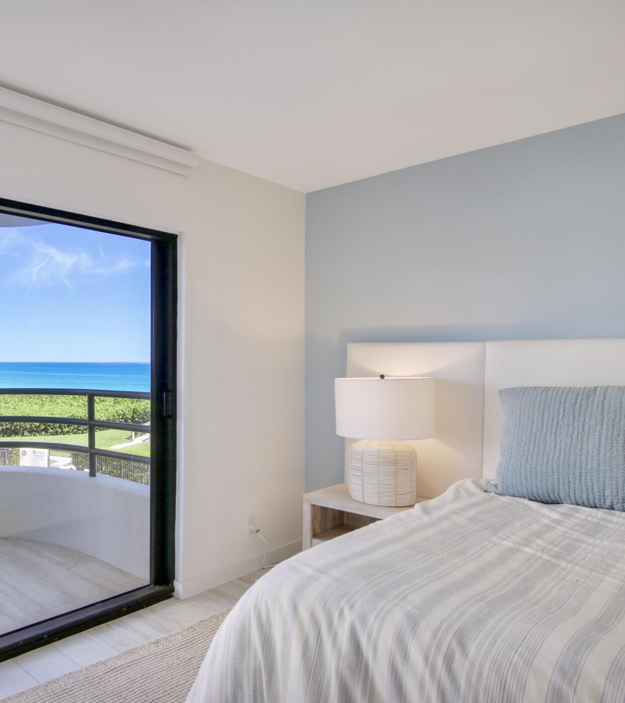 420 Celestial Way, Unit 303 Juno Beach, FL 33408 - Photo 25 of 39 a bedroom with a bed and a large window