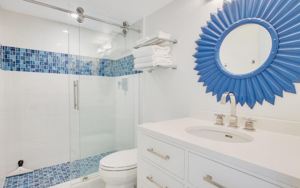 420 Celestial Way, Unit 303 Juno Beach, FL 33408 - Photo 29 of 39 a bathroom with a sink a toilet and a mirror