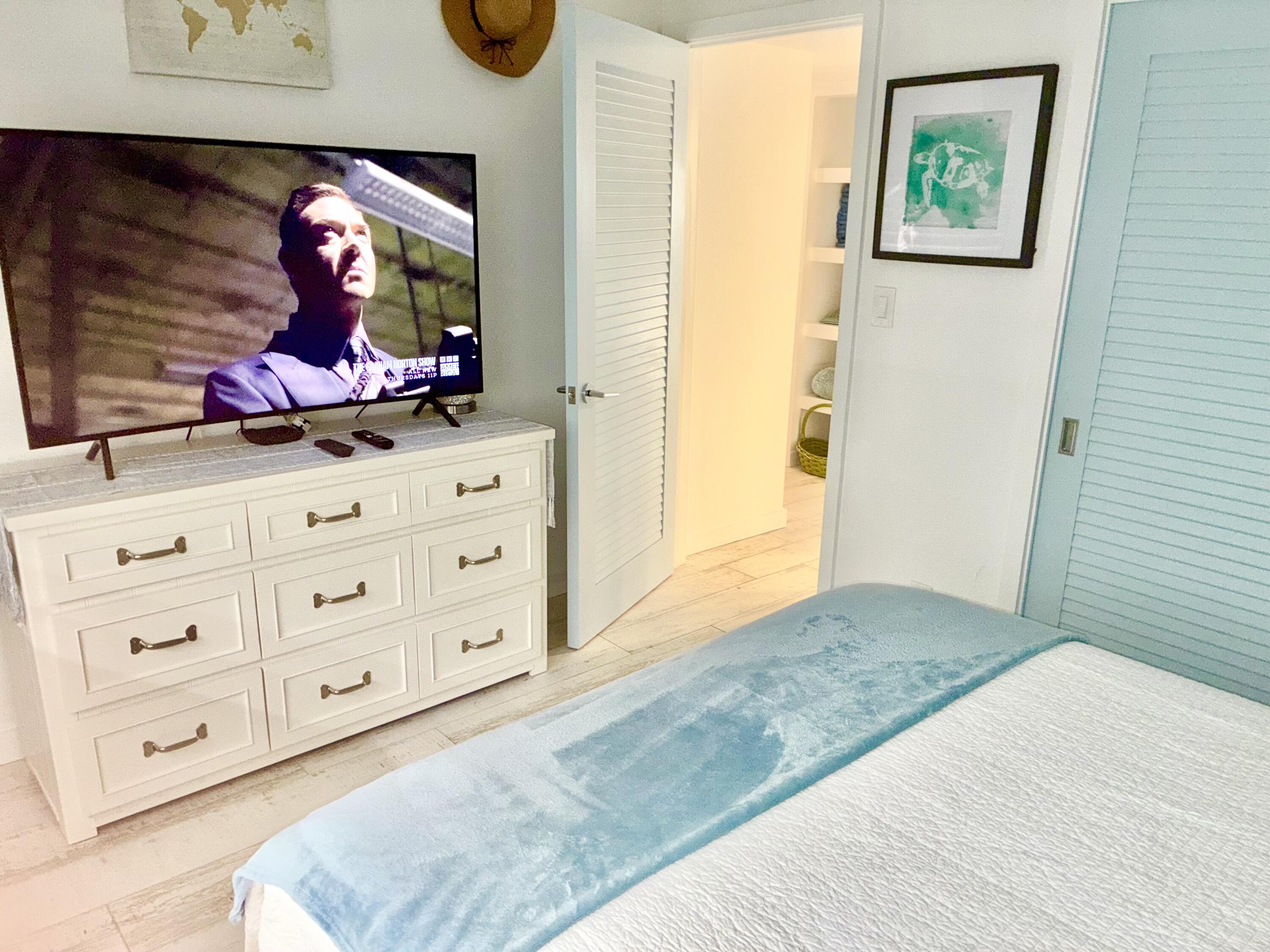 420 Celestial Way, Unit 303 Juno Beach, FL 33408 - Photo 32 of 39 a bedroom with a bed and a dresser in it