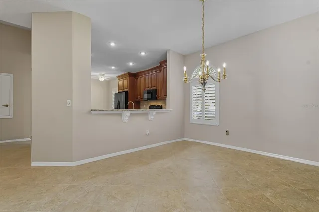a view of a dining room and livingroom with furniture a rug a fireplace and a large window