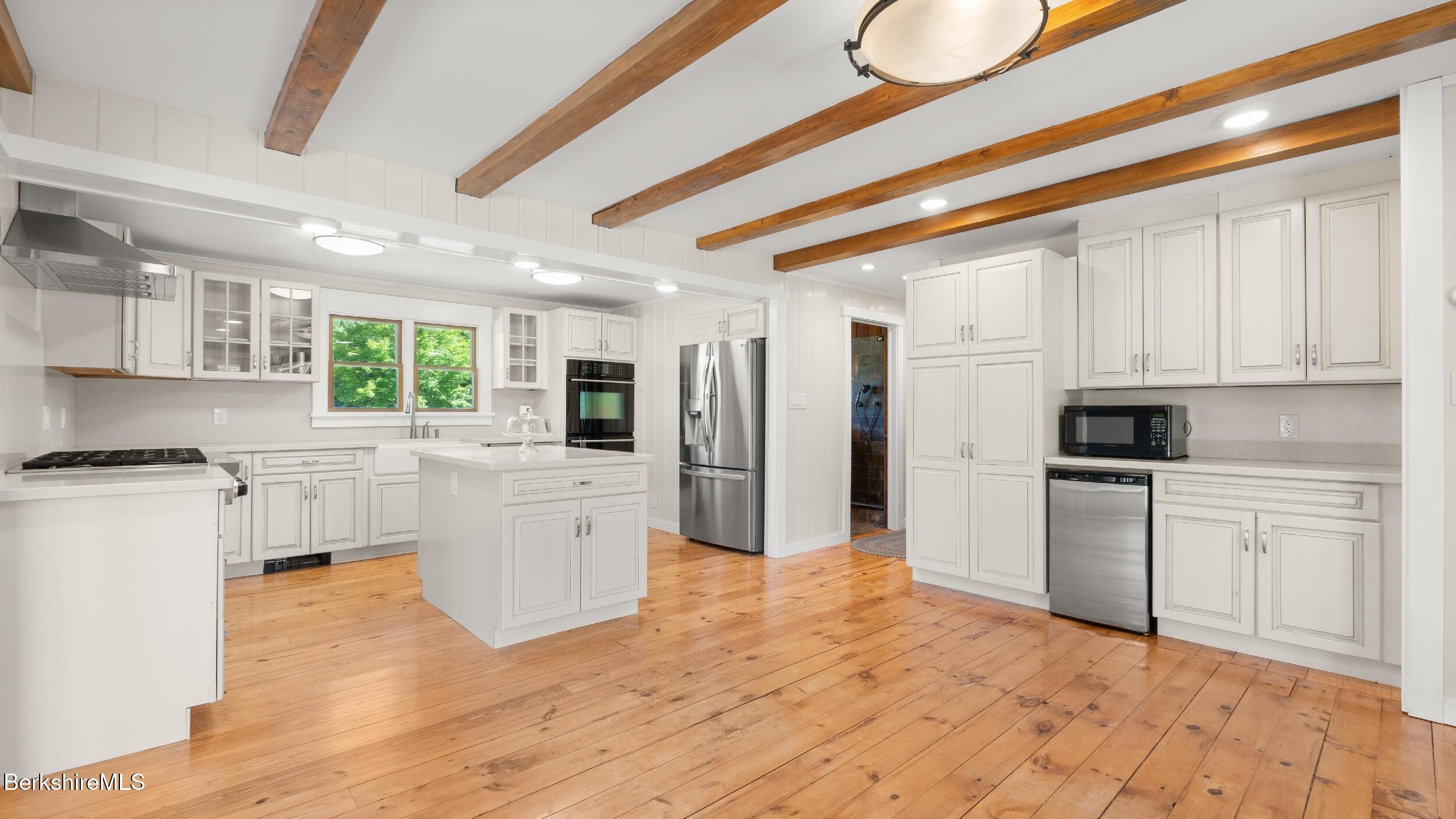 134 Hurlburt Road Great Barrington, MA 01230 - Photo 17 of 50 a kitchen with white cabinets and appliances