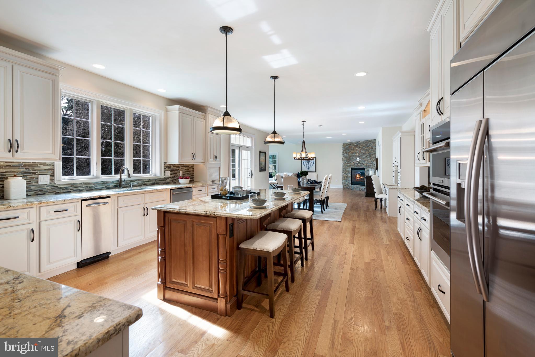 1315 Prospect Hill Road Villanova, PA 19085 - Photo 8 of 24 a large kitchen with kitchen island a large counter space a sink stainless steel appliances and cabinets