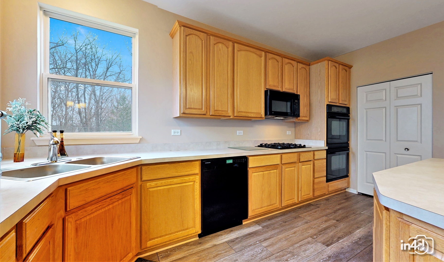 3 Ridge Court Bolingbrook, IL 60440 - Photo 11 of 52 a kitchen with granite countertop wooden cabinets a stove a sink and a window