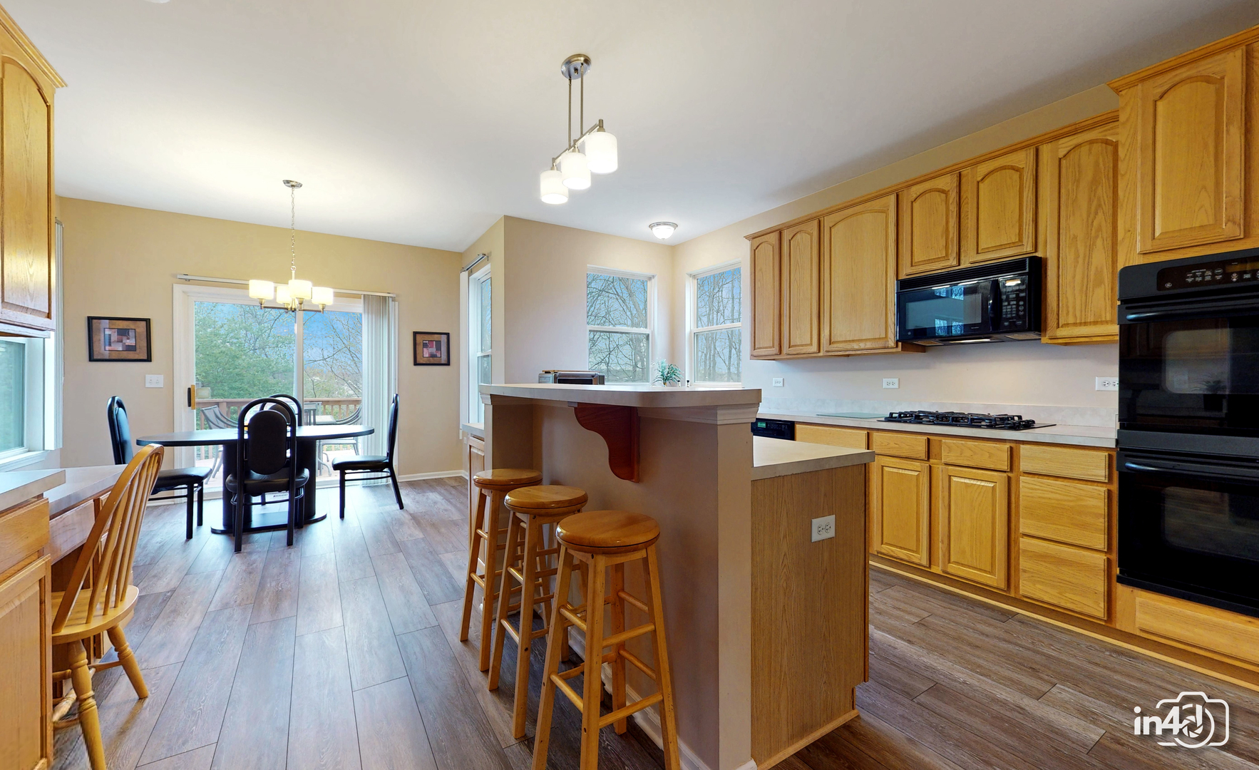3 Ridge Court Bolingbrook, IL 60440 - Photo 13 of 52 a kitchen with stainless steel appliances granite countertop a stove top oven a sink dishwasher a dining table and chairs with wooden floor