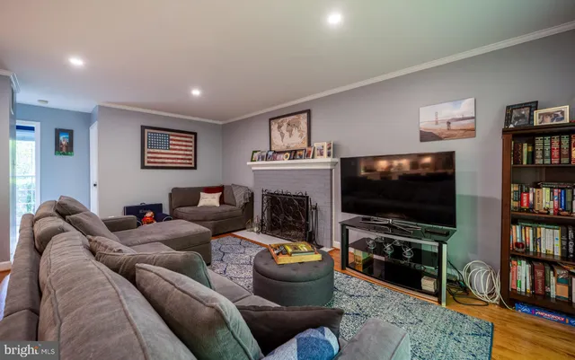 a dining room with furniture a chandelier and wooden floor