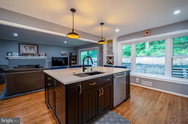 a large bed sitting in a bedroom next to a window and a chandelier