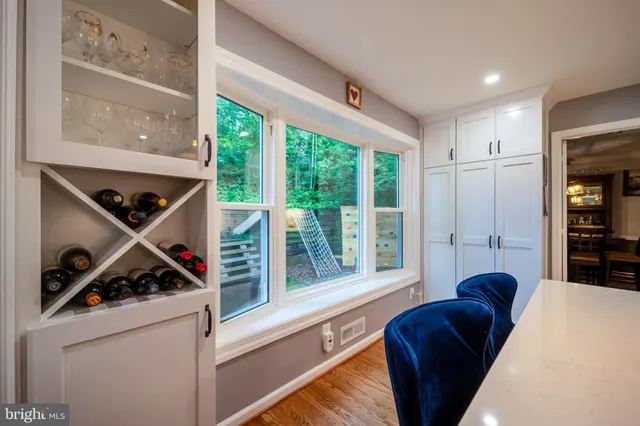 a spacious bathroom with a double vanity sink a large mirror and shower