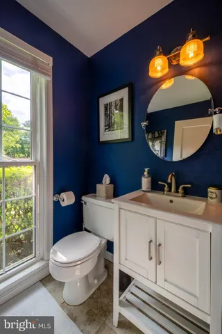 a bedroom with a bed and a mirror on dresser