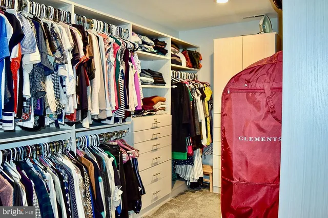 a bedroom with furniture and a flat screen tv