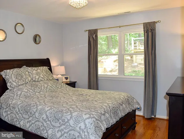 a living room with furniture a air conditioner vent and a window