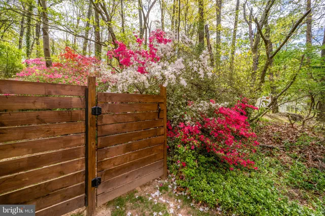a dining room with stainless steel appliances kitchen island a table chairs and a refrigerator