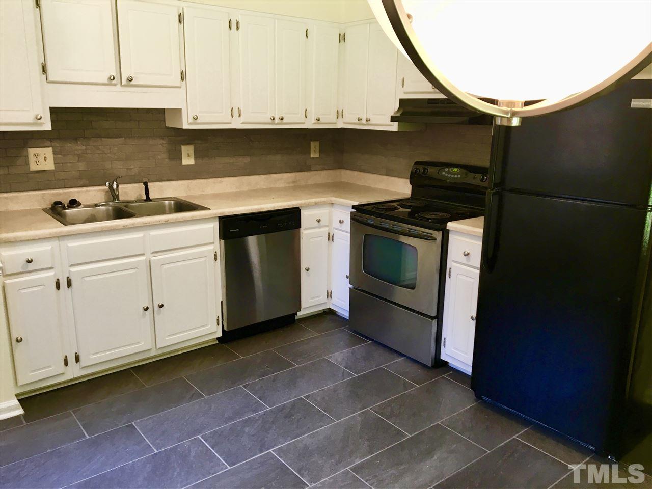 6504 Keystone Drive Raleigh, NC 27612 - Photo 8 of 17 a kitchen with a sink stove and cabinets