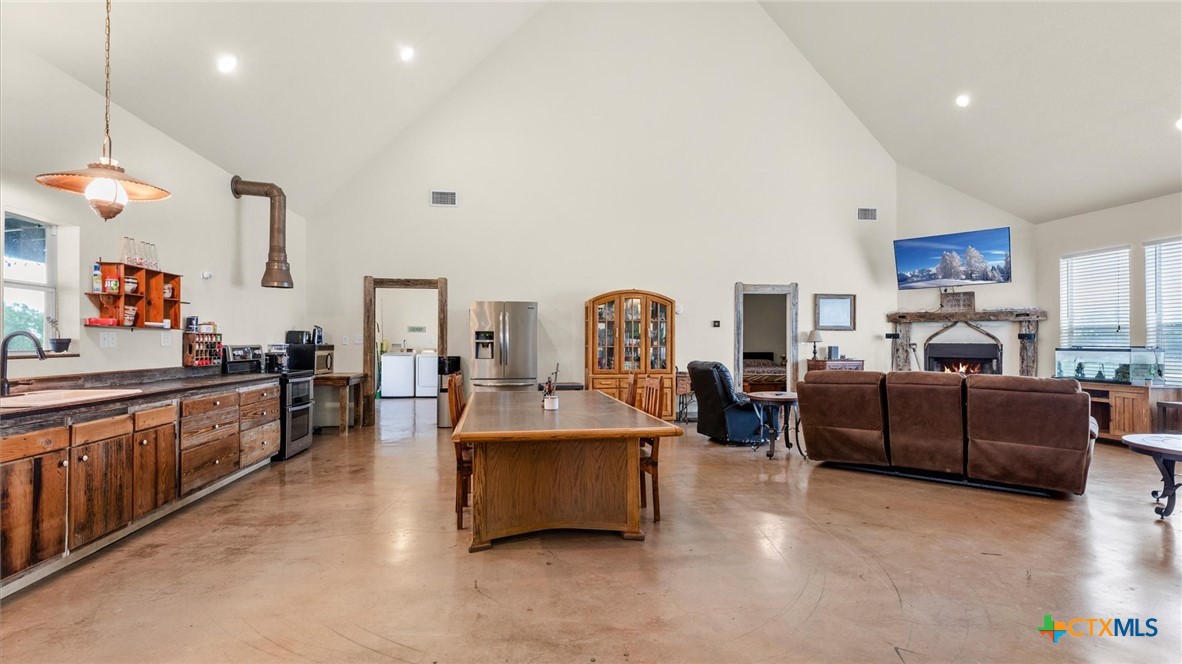 707 Creek Road Marion, TX 78124 - Photo 6 of 32 a living room with furniture and a kitchen