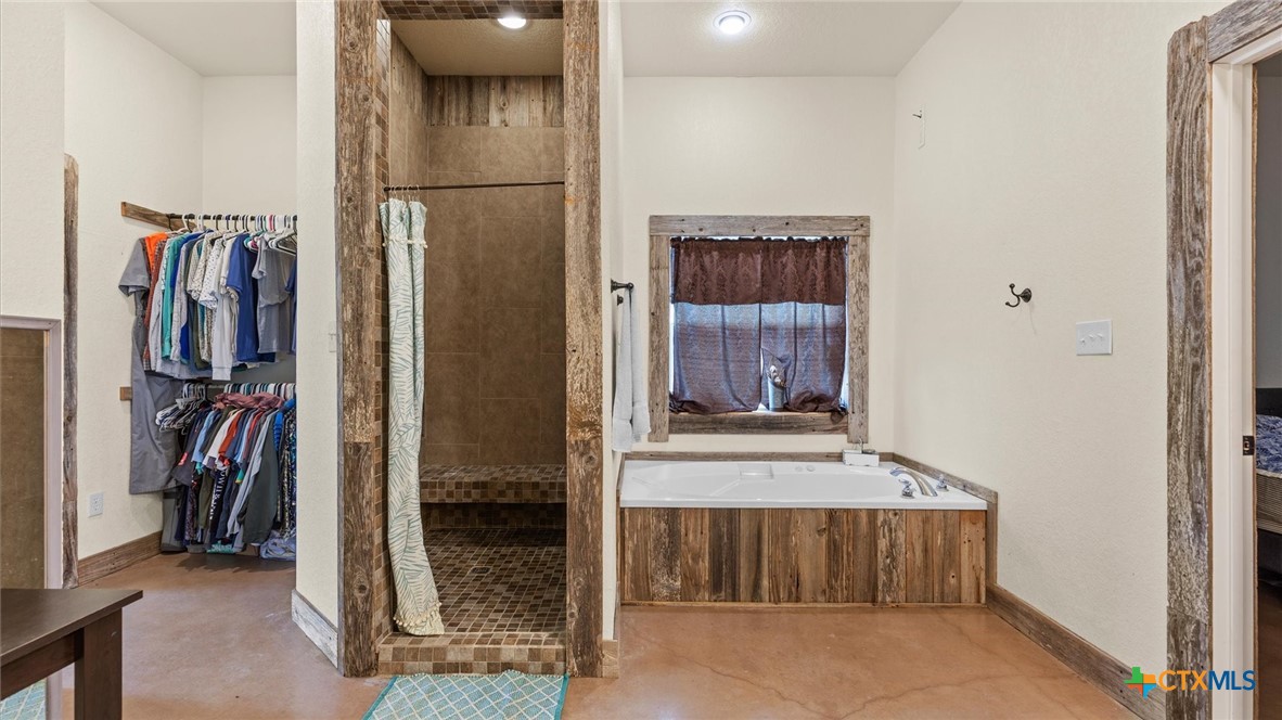 707 Creek Road Marion, TX 78124 - Photo 10 of 32 a view of walk in closet with clothes and shoes