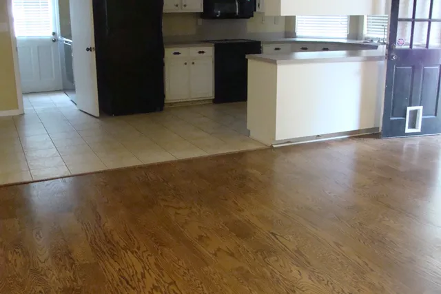 a kitchen with a refrigerator and a stove top oven