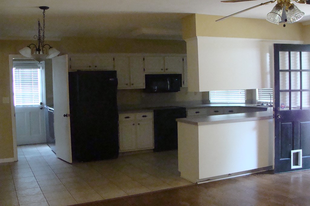 2215 Coventry Drive Columbus, GA 31904 - Photo 13 of 24 a kitchen with a refrigerator and a stove top oven